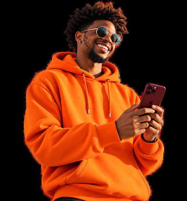 Smiling man in an orange hoodie checking the Runway app on his phone